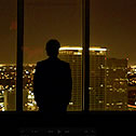 Man silhouetted against a night-time city skyline